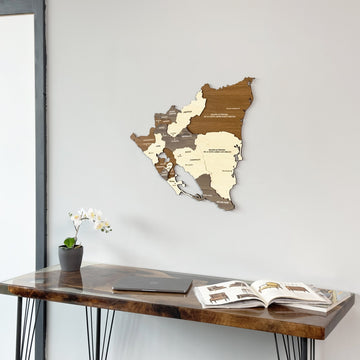 Nicaragua wood wall map above a dark desk with a laptop, closer view