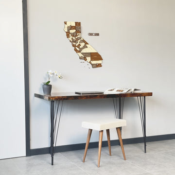 California wooden wall map wide view above a slim desk