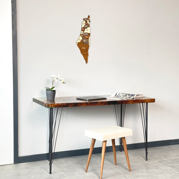 Palestine wooden wall map above a desk with a stool, mid-distance view from the left