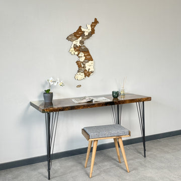 Korea wooden wall map above a desk, slightly higher on the wall, with a reed diffuser