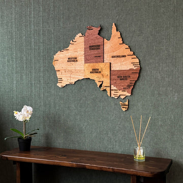 Australia plywood wall map with state names above a dark console, close crop