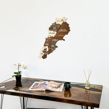 Lebanon wooden wall map seen from lower angle above a walnut resin desk with an orchid