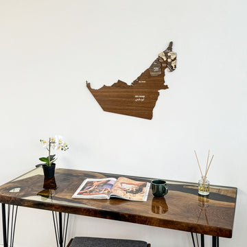United Arab Emirates wooden wall map above the end of a resin desk, side view