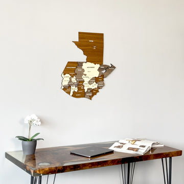 Guatemala wooden wall map seen at an angle from below, above a glossy resin desk