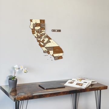 California wooden wall map with CALIFORNIA lettering above the corner of a dark desk