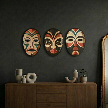 African masks metal wall art set on a dark wall above a wooden console