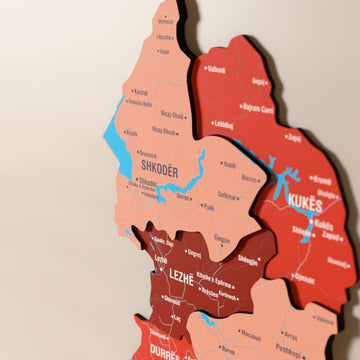Close-up of the Flag colored Albania wooden wall map with layered regions and printed names