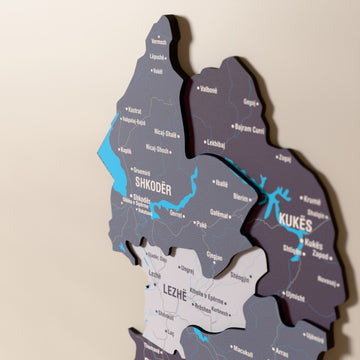 Close-up of the Nimbus Albania wooden wall map with layered regions and printed names