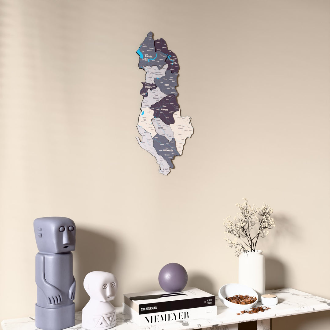 Nimbus Albania wooden wall map on a beige wall above a console with figurines