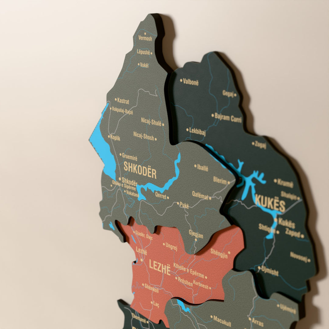 Close-up of the Sage Albania wooden wall map with layered regions and printed names
