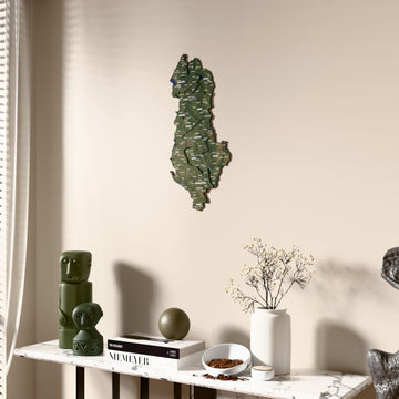 Satellite Albania wooden wall map beside a sheer curtain, angled view