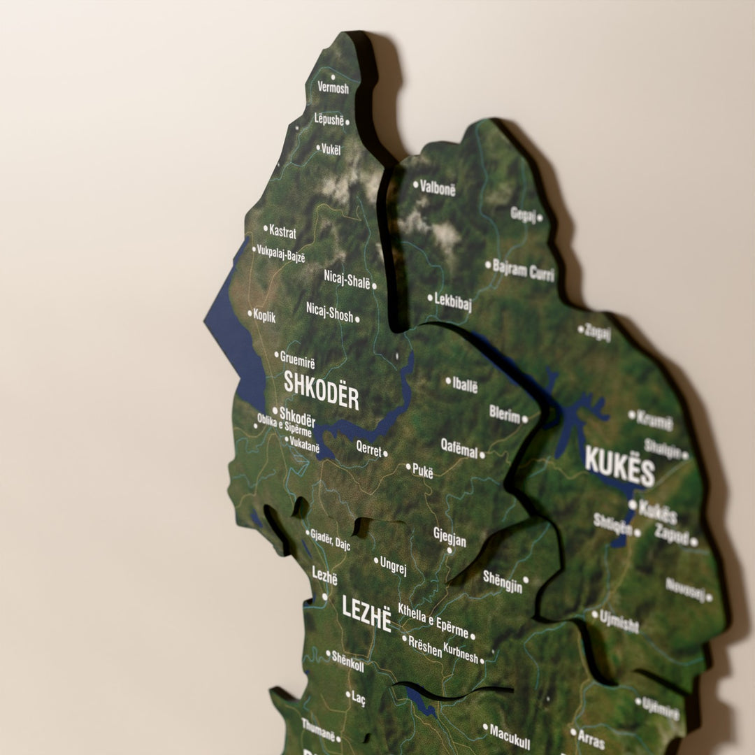 Close-up of the Satellite Albania wooden wall map with layered regions and printed names