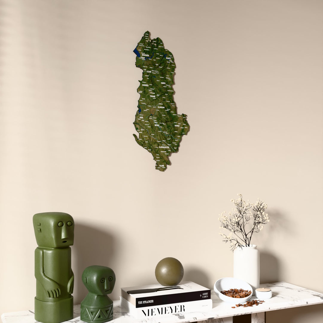 Satellite Albania wooden wall map on a beige wall above a console with figurines