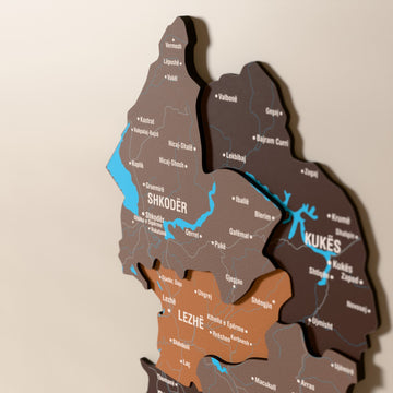Close-up of the Soil Albania wooden wall map with layered regions and printed names
