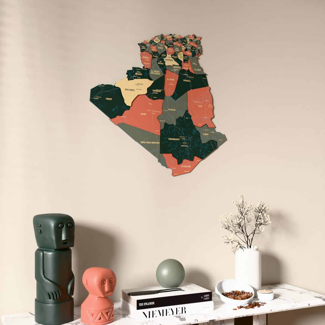 Sage Algeria wooden wall map on a beige wall above a console with figurines