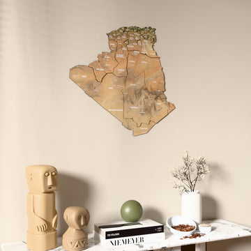 Satellite Algeria wooden wall map on a beige wall above a console with figurines
