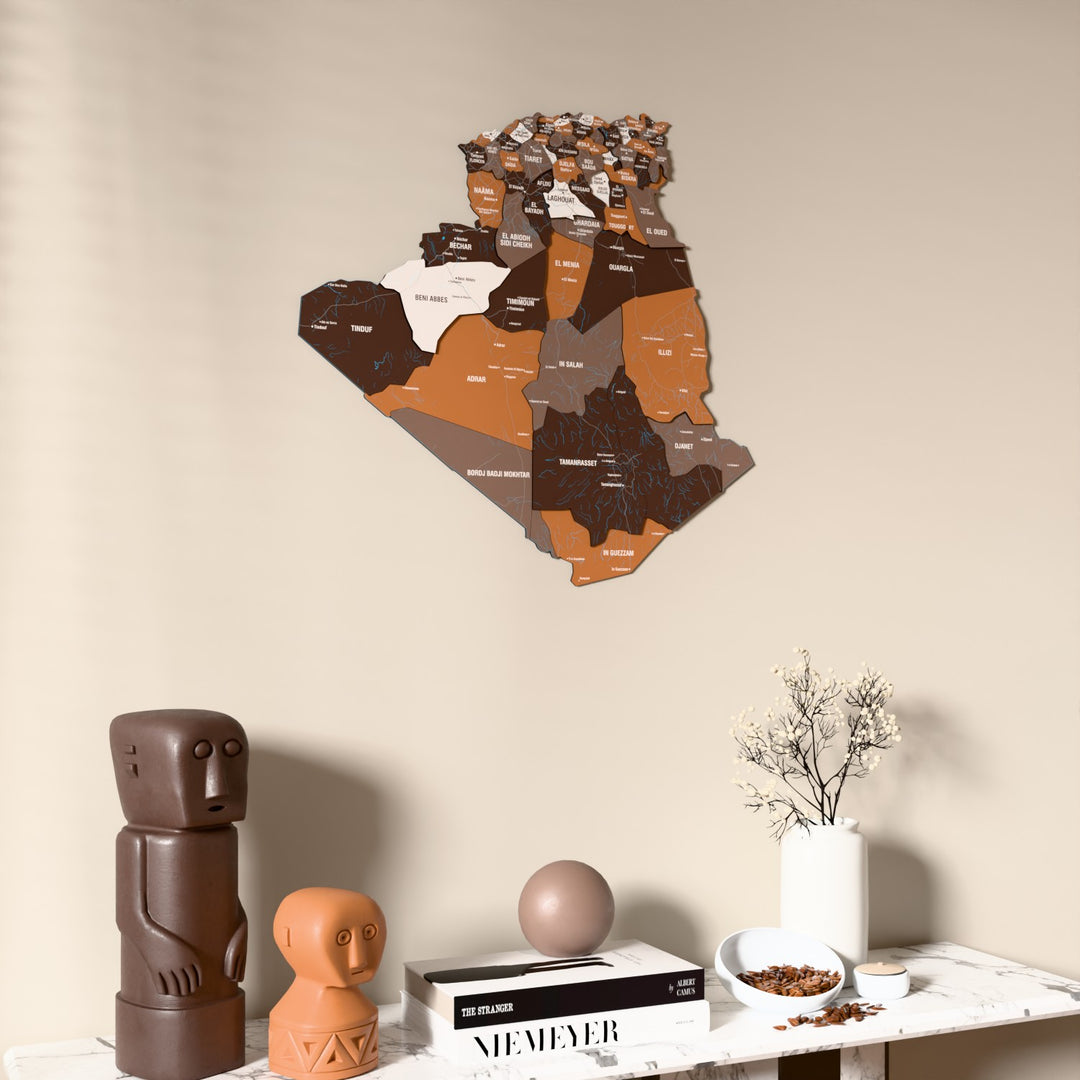 Soil Algeria wooden wall map on a beige wall above a console with figurines