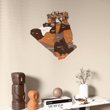 Soil Algeria wooden wall map on a beige wall above a console with figurines