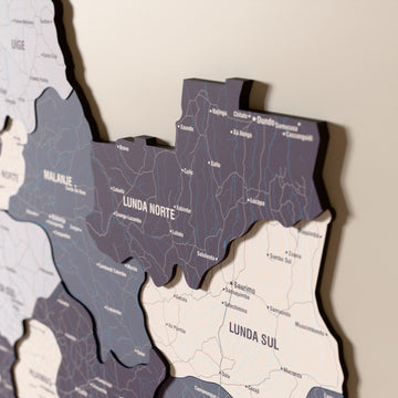 Close-up of the Nimbus Angola wooden wall map with layered regions and printed names