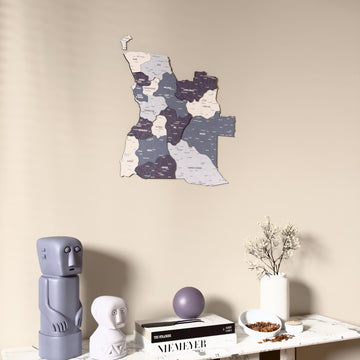 Nimbus Angola wooden wall map on a beige wall above a console with figurines