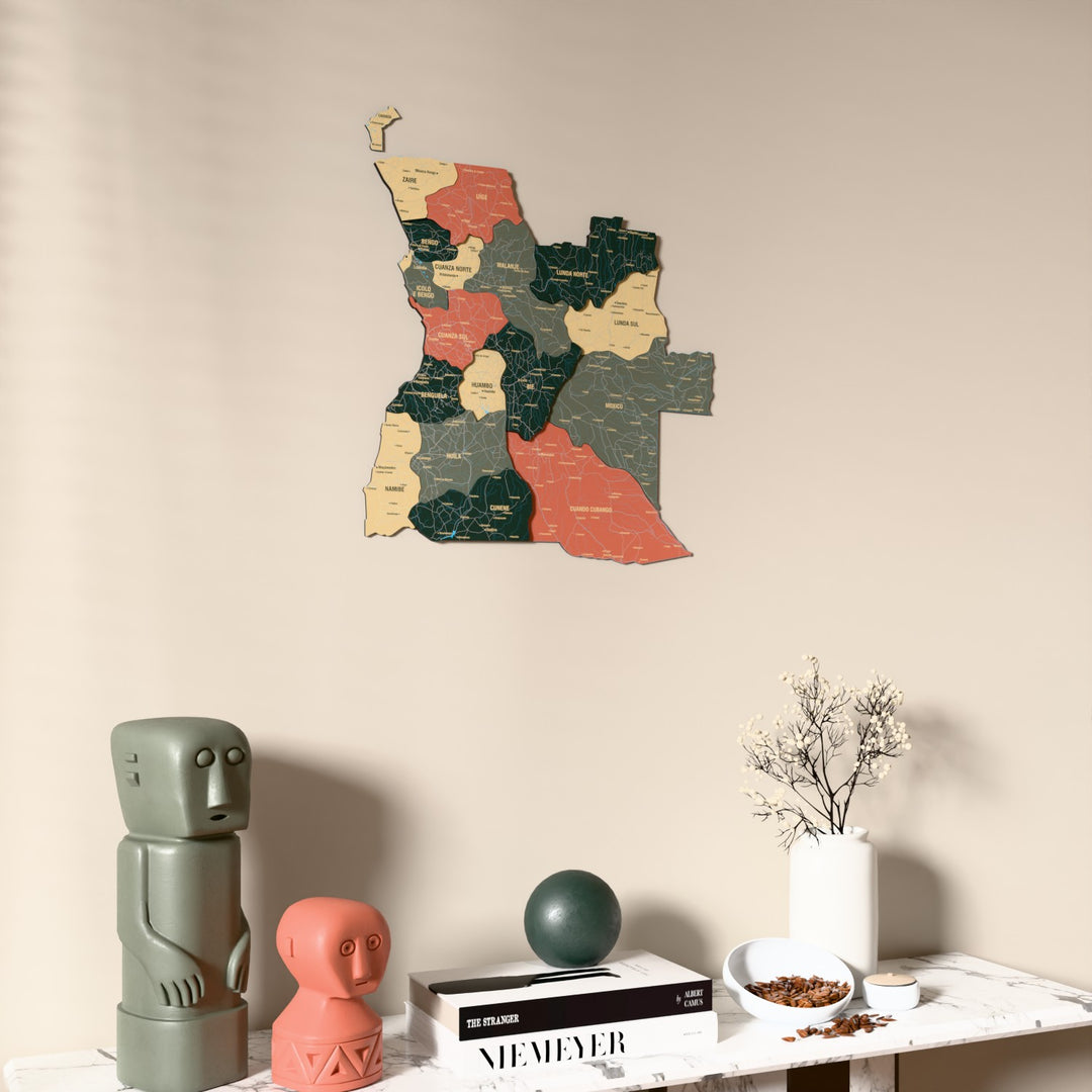 Sage Angola wooden wall map on a beige wall above a console with figurines