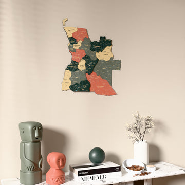 Sage Angola wooden wall map on a beige wall above a console with figurines