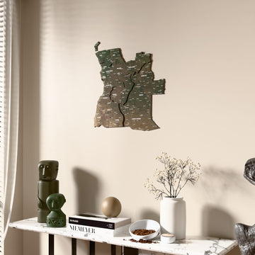 Satellite Angola wooden wall map beside a sheer curtain, angled view