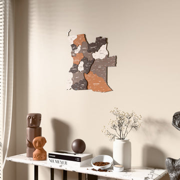 Soil Angola wooden wall map beside a sheer curtain, angled view
