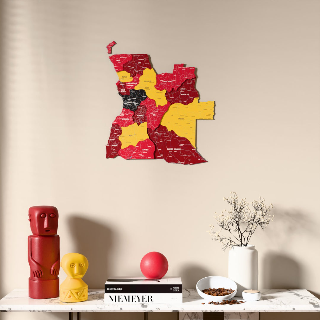 Flag colored Angola wooden wall map above a marble console, front view