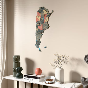 Sage Argentina wooden wall map beside a sheer curtain, angled view