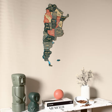 Sage Argentina wooden wall map on a beige wall above a console with figurines