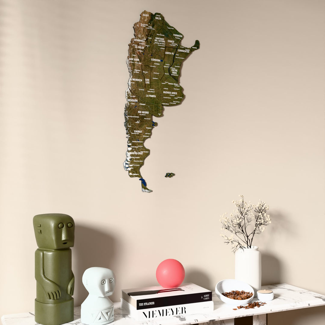 Satellite Argentina wooden wall map on a beige wall above a console with figurines