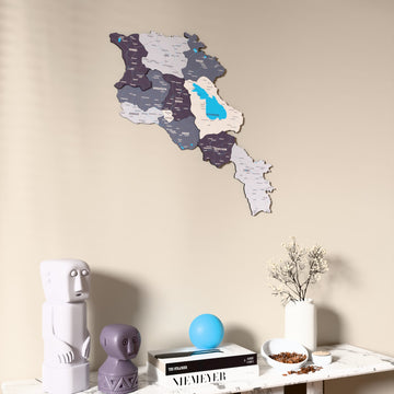 Nimbus Armenia wooden wall map on a beige wall above a console with figurines