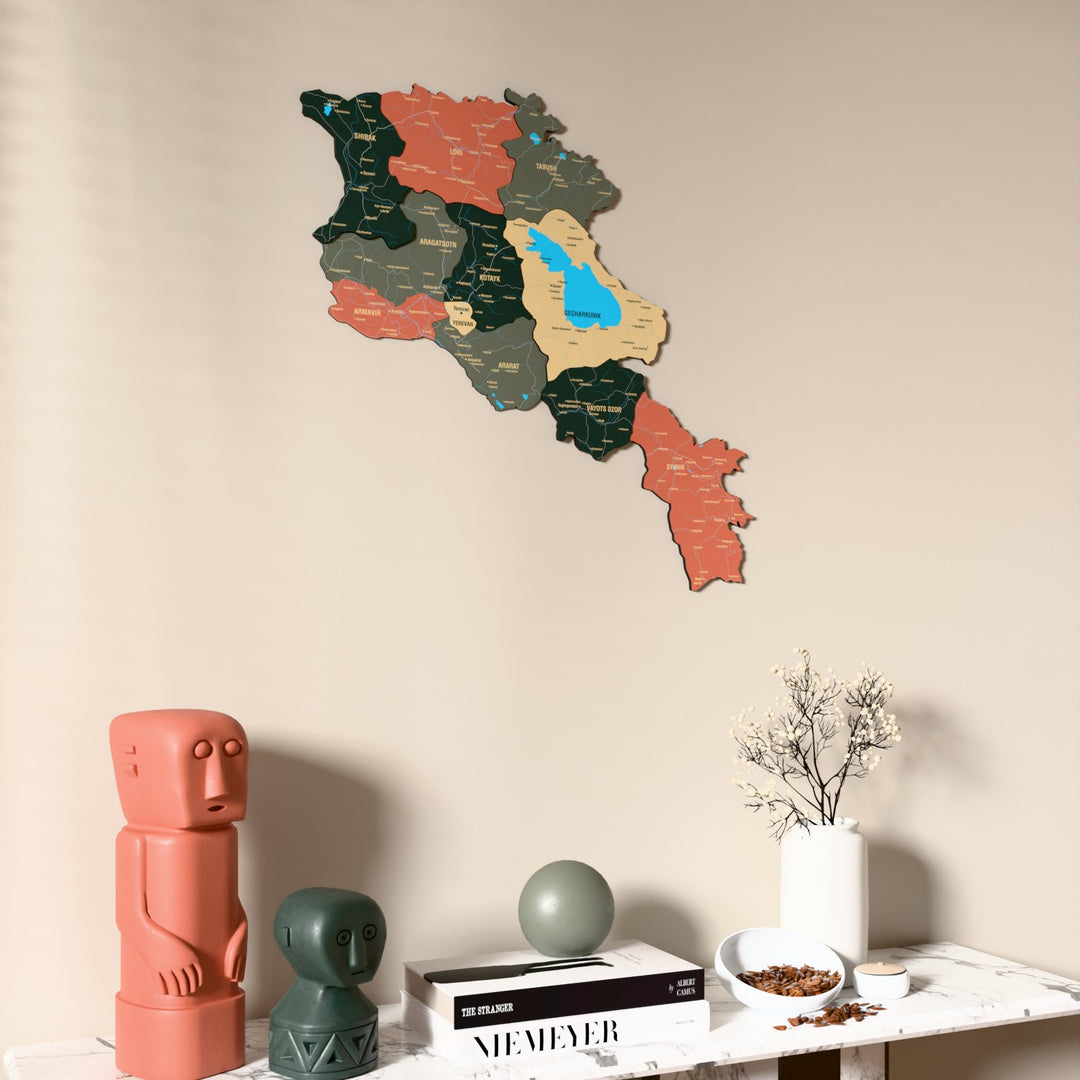 Sage Armenia wooden wall map on a beige wall above a console with figurines