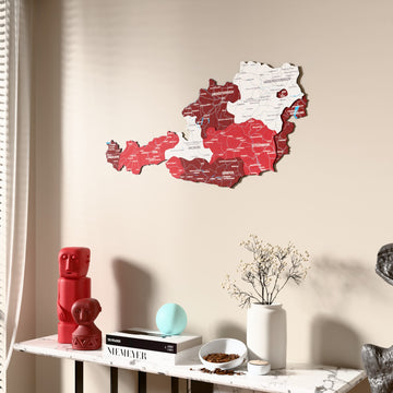 Flag colored Austria wooden wall map beside a sheer curtain, angled view