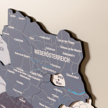 Close-up of the Nimbus Austria wooden wall map with layered regions and printed names