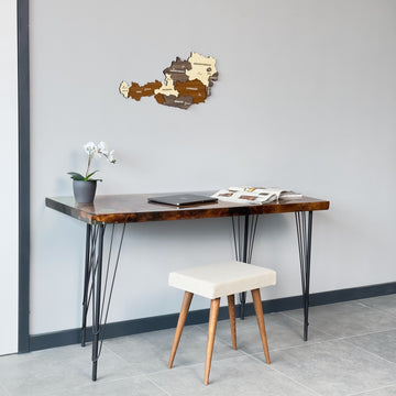Austria wooden wall map above a desk with a stool, mid-distance view