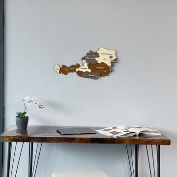 Small Austria wooden wall map above a resin desk with an orchid, tight crop