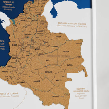 Close-up of the white framed Colombia cork map with department names from Chocó to Amazonas