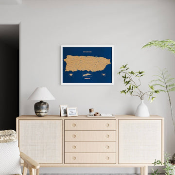 Small white-framed Puerto Rico cork map on a light wall, far view with a full rattan sideboard below