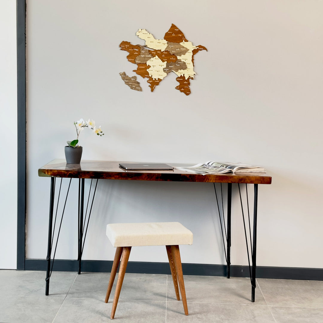 Azerbaijan wooden wall map above a hairpin-leg desk with a cream stool, full room view