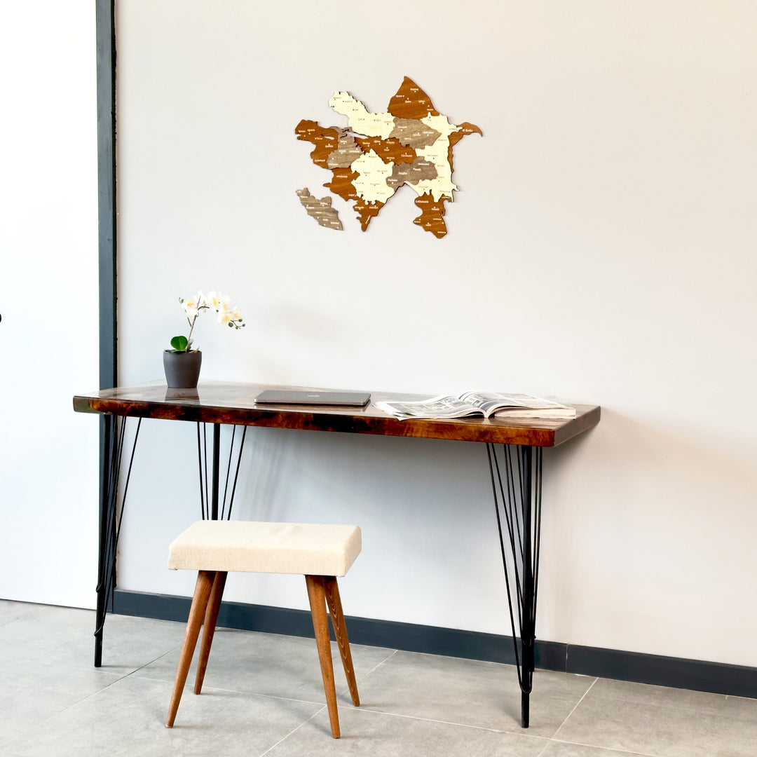 Azerbaijan wooden wall map small on a wall above a desk and stool, seen from a lower angle
