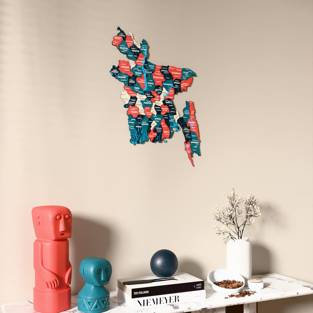 Flag colored Bangladesh wooden wall map on a beige wall above a console with figurines
