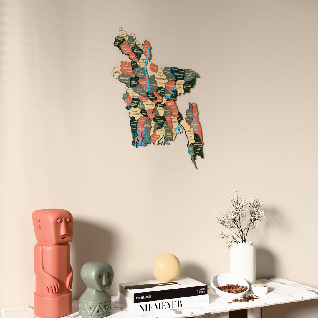 Sage Bangladesh wooden wall map on a beige wall above a console with figurines