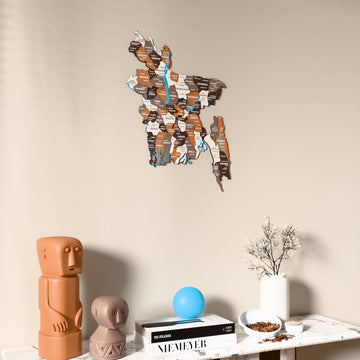 Soil Bangladesh wooden wall map on a beige wall above a console with figurines