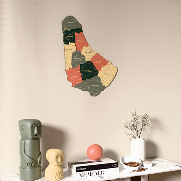 Sage Barbados wooden wall map on a beige wall above a console with figurines