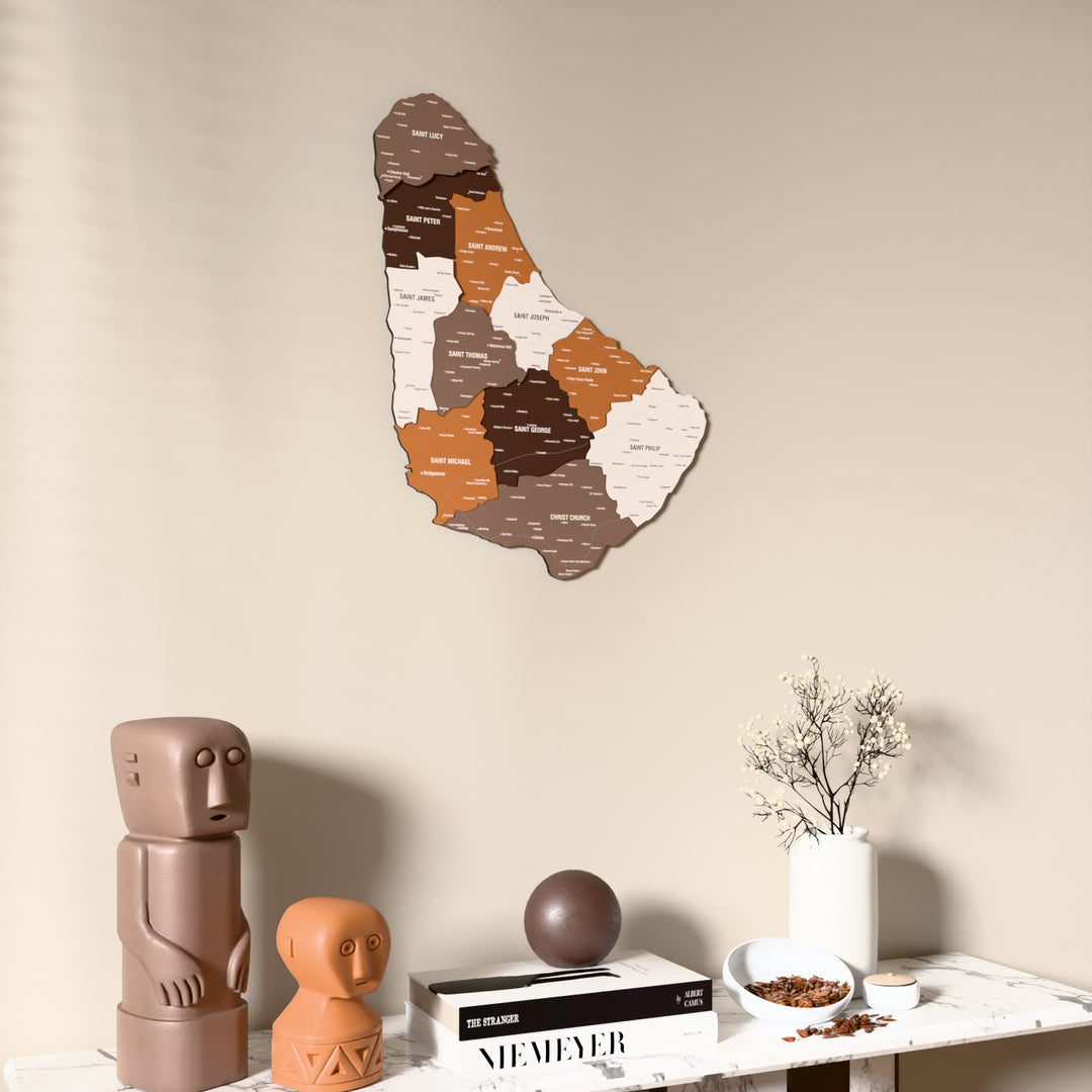 Soil Barbados wooden wall map on a beige wall above a console with figurines