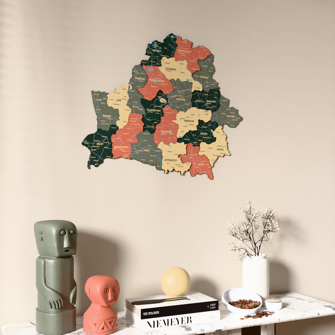 Sage Belarus wooden wall map on a beige wall above a console with figurines