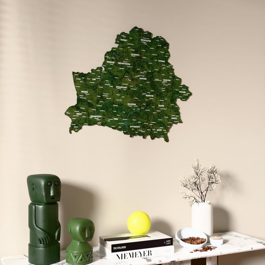 Satellite Belarus wooden wall map on a beige wall above a console with figurines