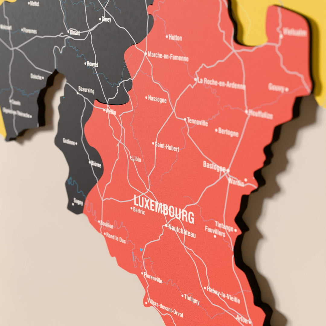 Close-up of the Flag colored Belgium wooden wall map with layered regions and printed names